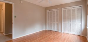 Empty apartment bedroom with hardwood floors