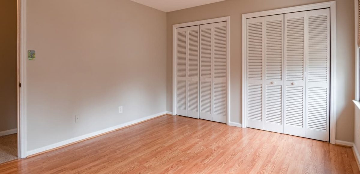 Empty bedroom with wooden floors