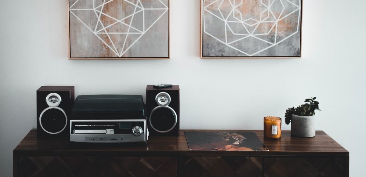 black shelf stereo on brown wooden sideboard