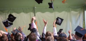 Graduates throwing their caps in the air in celebration