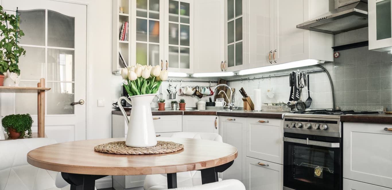Cream and white decorated kitchen in small space.
