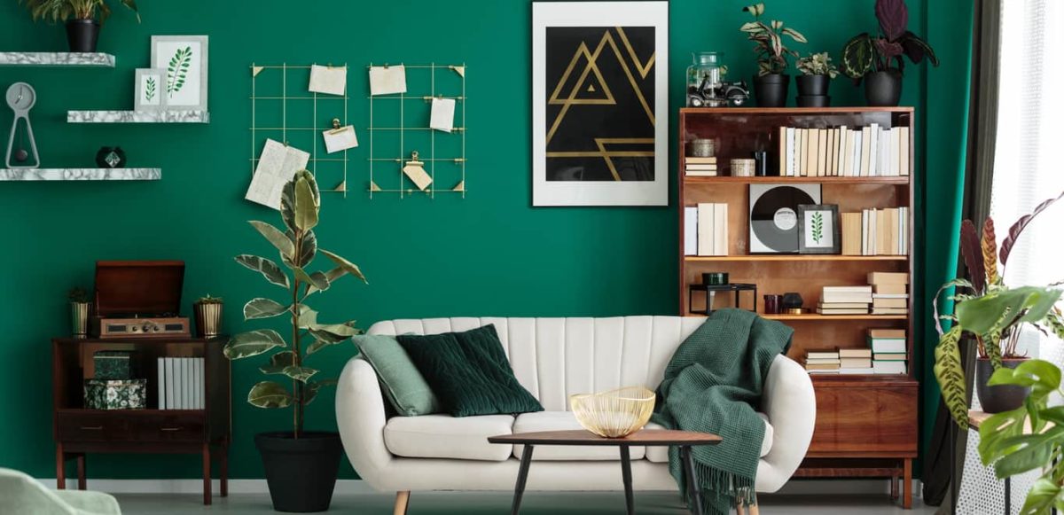 Green-themed living room with modern and vintage decor