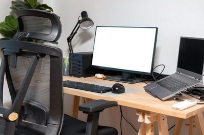 Comfortable chair, desk, and plant set up as a great example for how to create office in bedroom.