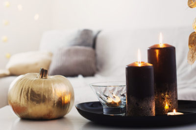 home decor with golden pumpkin and burning candles