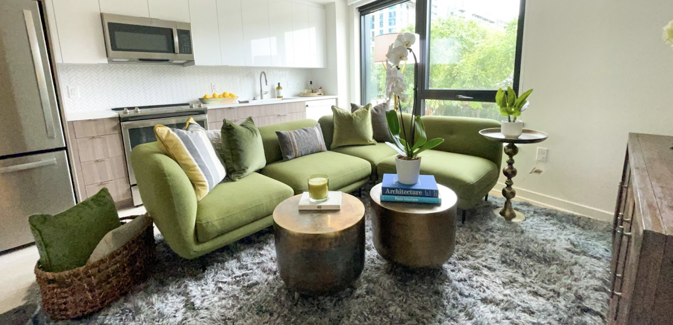 Green and neutral living room with classic furniture and accents from CORT Furniture Outlet