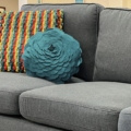 Home interior design style guide for finding your style with a transitional style featuring bright textured pillows and a simple grey sectional