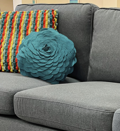 Home interior design style guide for finding your style with a transitional style featuring bright textured pillows and a simple grey sectional