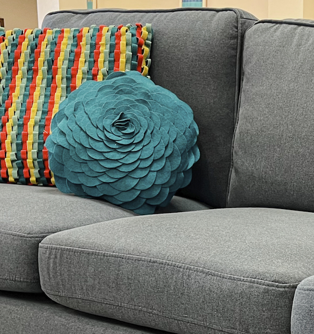 Home interior design style guide for finding your style with a transitional style featuring bright textured pillows and a simple grey sectional