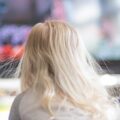 A child watching TV, their hair standing up with static electricity.