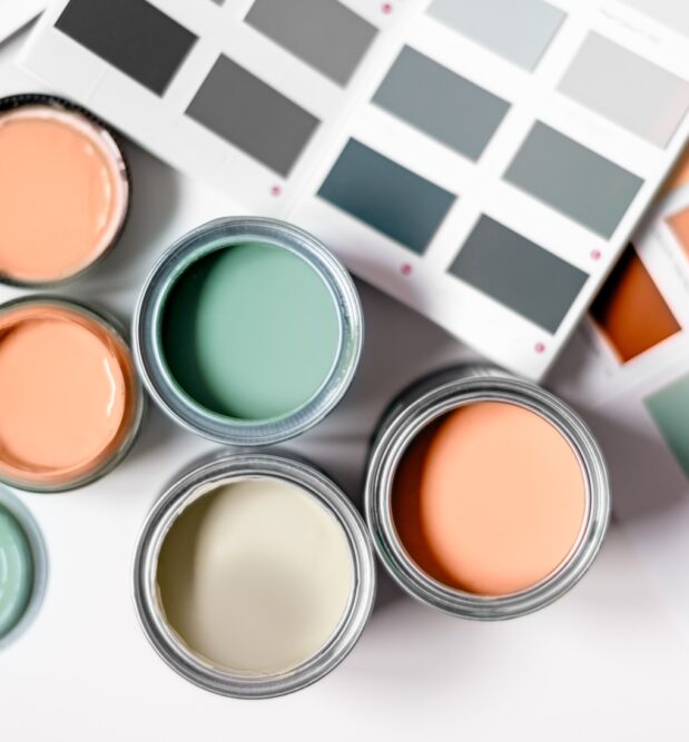 assortment of paint cans in trendy colors for budget friendly decorating tips and low cost interior design trends 2025