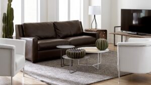 Luxurious living room with leather couch and accent pieces demonstrating decorating with metal. Follow CORT Furniture Outlet's tips for decorating with metal to learn how to mix metals in home design.
